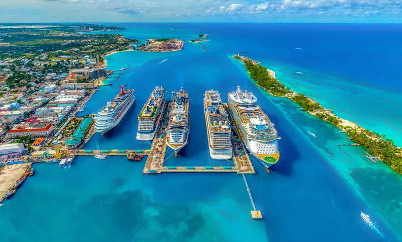 Cruise ships anchored beside a Caribbean island port