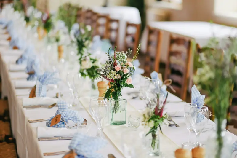 Long wedding table set with flowers and glassware