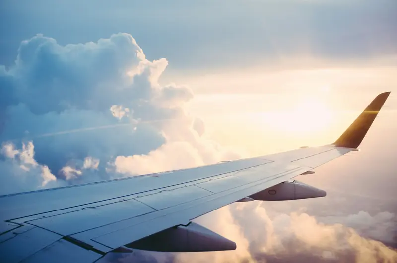 Aircraft wing over clouds on approach to Grand Cayman